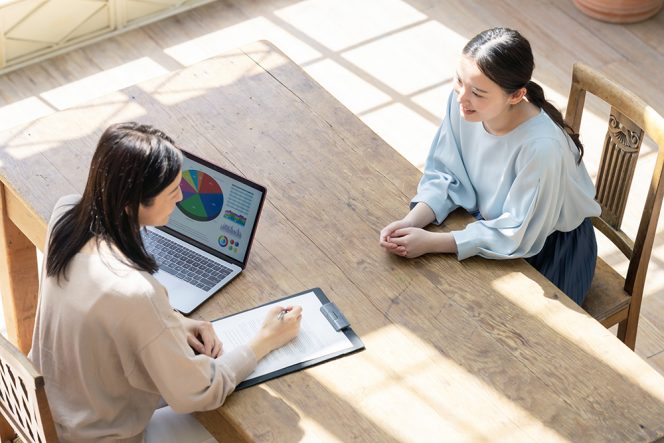 
Couple of woman consulting in modern room. High angle view.